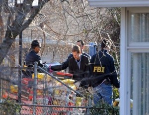 Feb. 17, 2012  Members of the FBI and police remove packages from a shed behind a house in the Douglas Park neighborhood of Arlington. Authorities raided the red-brick rambler after the arrest of a Moroccan man in a plot to attack the Capitol.  Tracy A. Woodward / The Washington Post